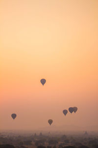 Hot air balloons in sky during sunset