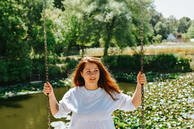 Young woman swinging at playground