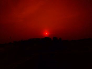 Scenic view of silhouette landscape against sky at night