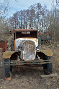 Abandoned truck on land against sky