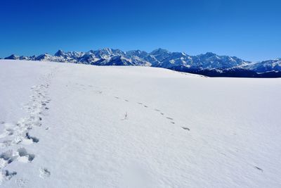 Scenic view of snow covered mountains against sky
