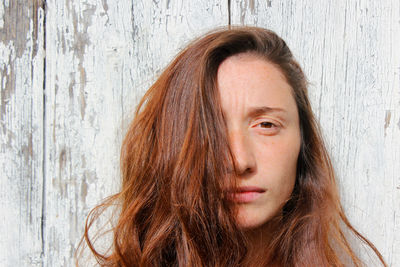 Woman portrait on the wooden background. young beautiful ginger woman. pretty face.