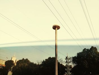 Low angle view of electricity pylon against sky