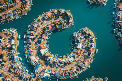 High angle view of ferris wheel by sea