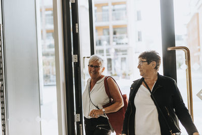 Senior women entering building