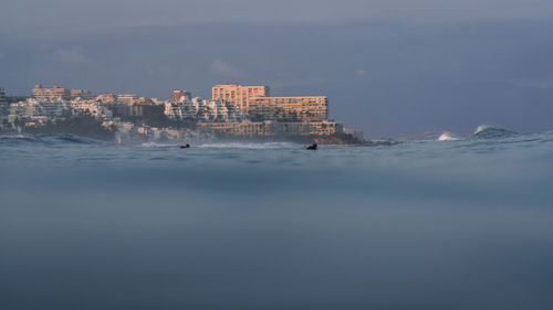 Buildings in city against sky during winter