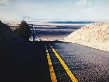 Road by sea against sky