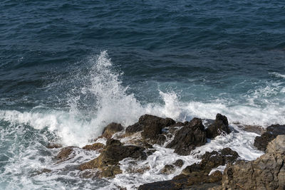 Waves splashing on rocks at shore