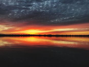 Scenic view of lake against romantic sky at sunset