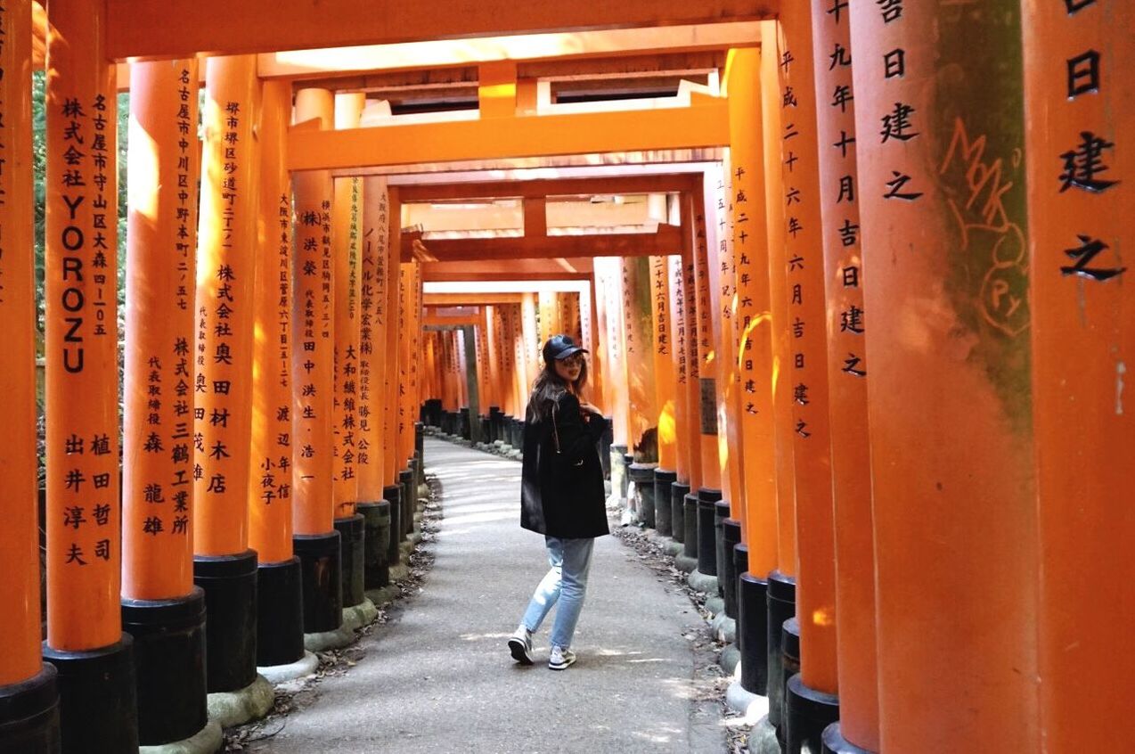 rear view, one person, full length, orange color, real people, architecture, built structure, architectural column, lifestyles, day, walking, travel, men, in a row, building, the way forward, communication, direction, place of worship, diminishing perspective, outdoors, shrine