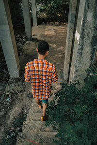 Rear view of boy standing outdoors