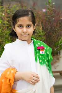 Portrait of a smiling girl standing outdoors