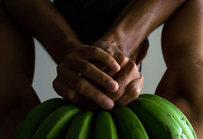 Close-up of man holding bananas