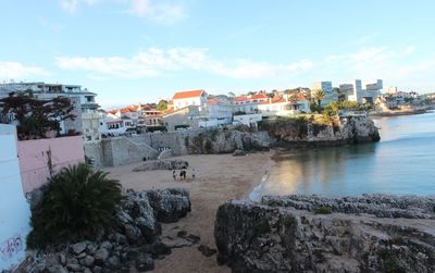 Panoramic view of sea and buildings against sky