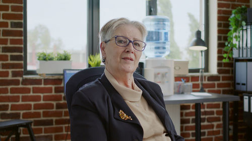 Portrait of senior woman sitting in clinic