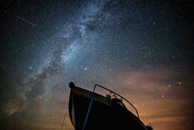 Low angle view of boat against starry sky at night