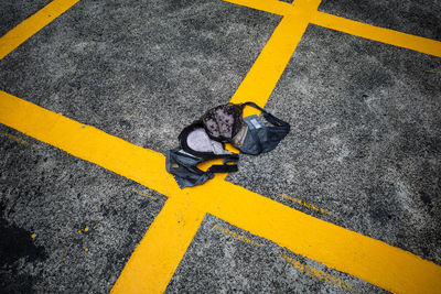 High angle view of man crossing sign on road