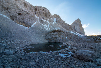 Stream against mountains during winter