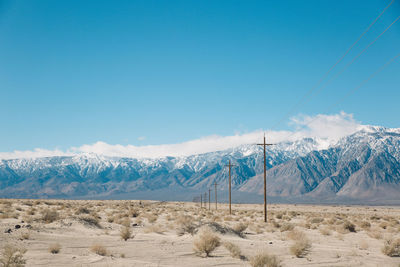 Scenic view of mountains against blue sky