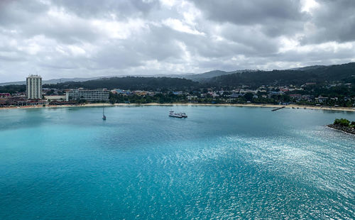 Scenic view of sea and city against sky