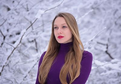 Young woman with blond hair standing outdoors during winter