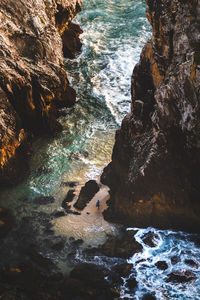 High angle view of rock formations by sea