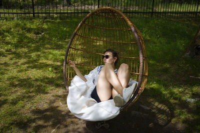 Young woman sitting on grass