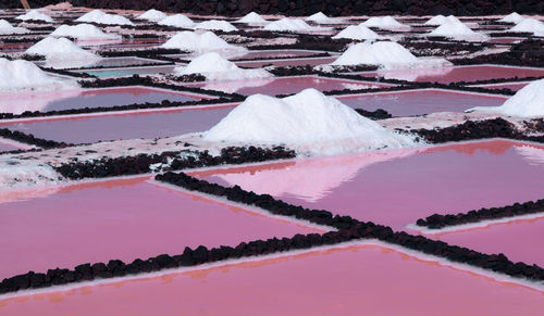 Salt flats farms showing red pink water in la palma canary island 