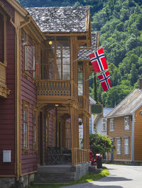 View of wooden house with danish flags on porch