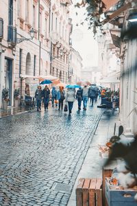 People walking on street in city