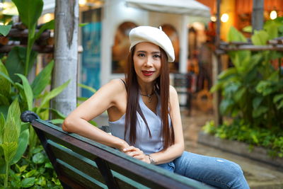 Portrait of smiling woman sitting on seat