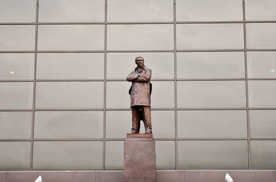 Man standing against wall