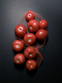 Red tomatoes on a dark moody background