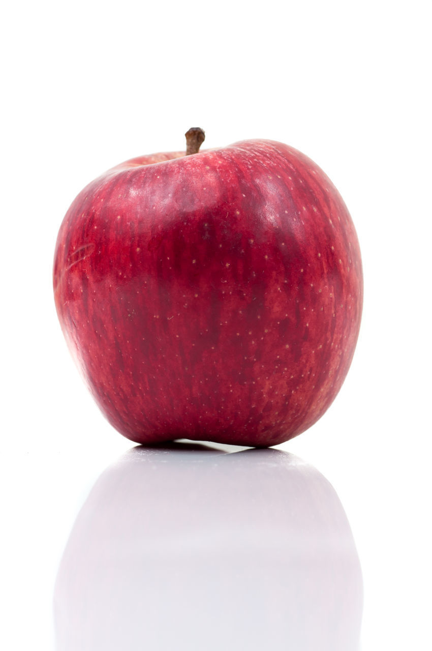 CLOSE-UP OF RED FRUIT AGAINST WHITE BACKGROUND