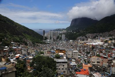 View of cityscape against cloudy sky