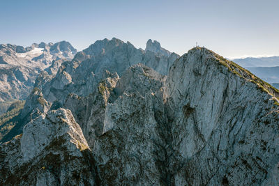 Aerial image of a group of climbers on top of mountain peak, gosaukamm, austria.