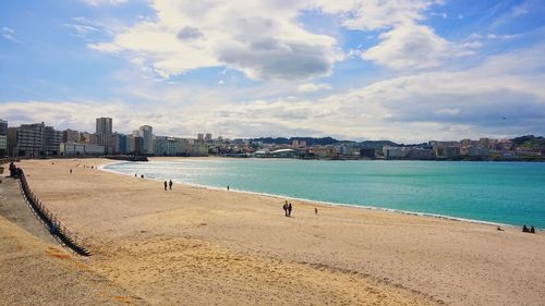 View of sea and buildings against sky