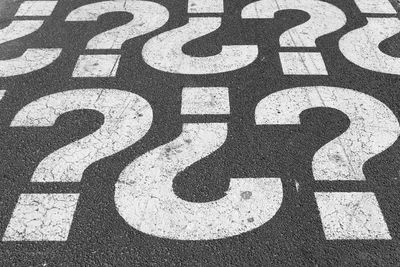 High angle view of question marks on road