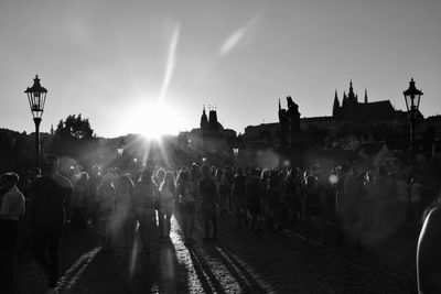 People on street in city against sky