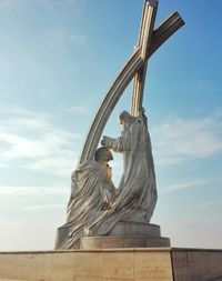 Low angle view of statue against sky