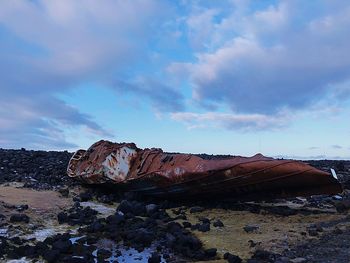 Abandoned rocks on land against sky