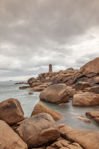 Panoramic view of the famous ploumanach lighthouse among the giant pink boulders in brittany