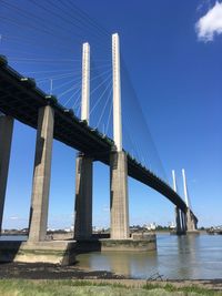 Low angle view of suspension bridge against sky