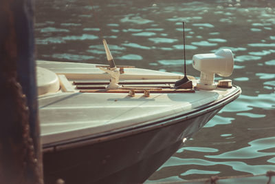 Close-up of boat moored in lake