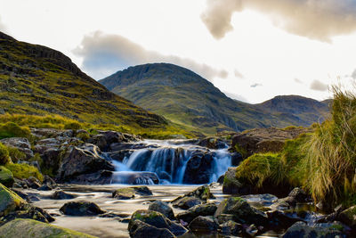 Scenic view of waterfall against sky