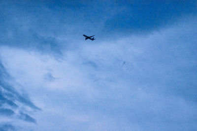 Low angle view of airplane flying in sky