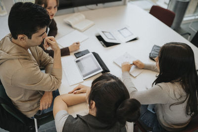 High angle view of students discussing at table in university