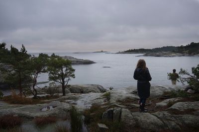 Rear view of woman standing on beach