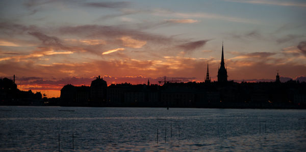 View of buildings against cloudy sky during sunset