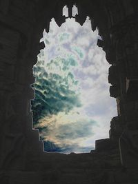 Low angle view of building against cloudy sky